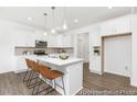 Bright kitchen with white cabinets, marble countertops, and pendant lighting at 105 Mable Court # 10, Lillington, NC 27546