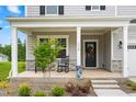 Inviting front porch with rocking chairs creates a welcoming entrance to this charming home at 110 Hickory Grove Dr, Sanford, NC 27330
