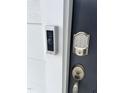 Up-close look at front door with smart lock and Ring doorbell for added security and convenience at 1116 Merlot Hills Ln, Durham, NC 27704