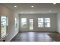 Bright living room featuring hardwood floors, ample windows, and a modern, open-concept design at 1116 Merlot Hills Ln, Durham, NC 27704