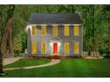 Inviting two-story home with a well-manicured lawn and a striking red front door at 114 Bonaparte Dr, Hillsborough, NC 27278