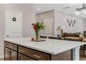 Bright kitchen island with quartz countertop and views to living room at 128 Potomac River St, Garner, NC 27529