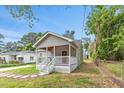 Inviting home exterior with a cozy porch and a well-maintained lawn at 128 W Parker St, Henderson, NC 27536