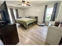 Comfortable bedroom with natural light, wood-look floors, a ceiling fan, and neutral decor at 1305 Shakentown St, Knightdale, NC 27545