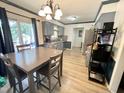 Eat-in kitchen featuring gray cabinets, stainless steel appliances, and a sliding glass door at 1305 Shakentown St, Knightdale, NC 27545