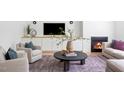 Inviting living room featuring a modern fireplace, built-in shelving, and stylish furnishings at 1405 Watts St, Durham, NC 27701