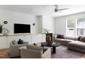 Cozy living room with a fireplace, comfortable seating, and neutral decor at 1405 Watts St, Durham, NC 27701