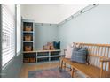 Light and airy mudroom with custom shelving, bench seating, and decorative accents at 1405 Watts St, Durham, NC 27701