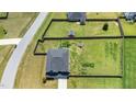 Aerial view of home showcasing the large fenced backyard, storage shed, garden beds, and playground at 171 Piney Field Rd, Fuquay Varina, NC 27526