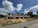 Row of new homes under construction on a sunny day, showing a two-story design at 184 W Allen St, Four Oaks, NC 27524