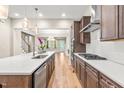 Modern kitchen featuring a center island, stainless steel appliances, pendant lighting, and hardwood floors at 192 Glenpark Pl, Cary, NC 27511