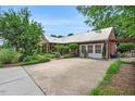 Spacious driveway complements a brick home with well-maintained landscaping at 202 Hilltop Ave, Garner, NC 27529