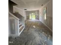 Bright living room with stairs, neutral walls, and French doors to the backyard at 203 S Main St # B, Four Oaks, NC 27524