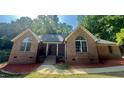 Charming brick home featuring arched windows and a cozy front porch at 2032 Sherry Lynn Dr, Garner, NC 27529