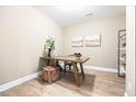 Bright office space boasts a modern desk, wood floors, and calming artwork at 209 Broomgrove Way, Wake Forest, NC 27587