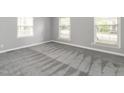 Spacious bedroom with neutral carpet, three windows, and ample natural light at 223 Shadowbrook Dr, Burlington, NC 27215