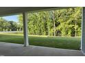 Spacious backyard view from the covered porch of a new home, overlooking lush green landscape at 2313 Abbeyhill Dr # 3, Raleigh, NC 27610