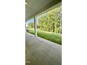 Covered porch showcasing view of large grassy backyard surrounded by mature trees at 2313 Abbeyhill Dr # 3, Raleigh, NC 27610