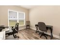 Bright office space with natural light, wood floors, and room for multiple workstations at 2501 Impulsion Dr, New Hill, NC 27562