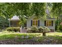 Home exterior showcasing well-maintained lawn and shrubbery, and walkway at 2805 Evans St, Durham, NC 27705