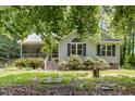 Inviting home exterior with a covered porch, well-manicured shrubs, and bright lawn at 2805 Evans St, Durham, NC 27705