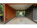 Large carport with slatted walls and concrete floor provides plenty of covered parking and storage at 307 Yowland Rd, Henderson, NC 27536