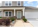 Charming two-story home with a manicured front yard and attached two-car garage at 34 Tanglewood Pl, Angier, NC 27501