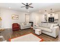 Spacious living room features hardwood floors, ceiling fan, and neutral paint scheme at 34 Tanglewood Pl, Angier, NC 27501