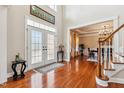 Elegant foyer with French doors, hardwood floors, and views into the formal dining room at 3404 Mount Pisgah Way, Cary, NC 27519