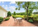 Back patio area features an outdoor seating area on brick pavers and mature landscaping at 360 Country Way, Sanford, NC 27332
