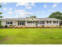 Charming single story home featuring a beautiful front lawn, mature landscaping and inviting front porch at 360 Country Way, Sanford, NC 27332