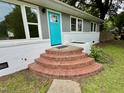 Close up of the entrance to a single-story home with brick steps at 3804 Cobb St, Garner, NC 27529