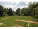 View from the deck overlooks a spacious and lush backyard surrounded by mature trees and landscaping at 4109 Stonewall Dr, Raleigh, NC 27604