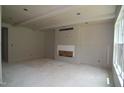 Spacious living room featuring a fireplace, bright windows, and drywall ready for finishing touches at 4109 Stonewall Dr, Raleigh, NC 27604