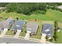 Aerial view of a neighborhood with well-manicured lawns and cozy homes, surrounded by lush greenery at 42 Village Walk Dr, Chapel Hill, NC 27517