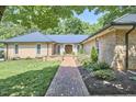 Beautiful brick home with a brick walkway leading to a lovely double door front entrance at 423 N Cameron St, Hillsborough, NC 27278