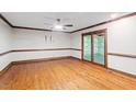 Spacious living room with gleaming hardwood floors and a large door with access to porch at 5125 Penny Rd, Raleigh, NC 27606