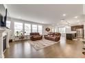 Spacious open-concept living room with hardwood floors, large windows, and modern furnishings at 5420 Mill Dam Rd, Wake Forest, NC 27587