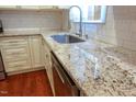 Close-up of granite countertops, stainless steel dishwasher, and white cabinetry, showcasing the kitchen's elegant features at 5917 Clearsprings Dr, Wake Forest, NC 27587