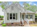 Charming home featuring a well-maintained yard and inviting front porch at 6004 Volant Dr, Raleigh, NC 27609