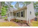 Well maintained home with beautiful flower bed and front entry with stairs at 6004 Volant Dr, Raleigh, NC 27609