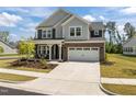 Charming two-story home with brick and siding, manicured lawn, and attached two car garage at 601 Lauren Ann Dr, Apex, NC 27523