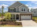 Charming two-story home with brick and siding, manicured lawn, and attached two car garage at 601 Lauren Ann Dr, Apex, NC 27523