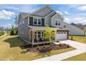 Charming two-story home with brick and siding, manicured lawn, and attached two car garage at 601 Lauren Ann Dr, Apex, NC 27523