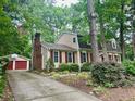 Inviting two-story house with red shutters, well-maintained landscaping and a detached garage at 702 Longleaf Dr, Chapel Hill, NC 27517