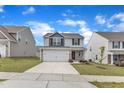Two-story house with vinyl siding, stone accents, well-kept lawn, and a paved driveway at 717 Little Patch St, Zebulon, NC 27597