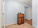 Hallway featuring an eclectic cabinet with tiled floors and pale blue walls at 790 Cashmere Ct, Sanford, NC 27332