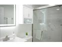Modern bathroom with glass shower, vanity, and bright, decorative lighting at 800 Pritchard Avenue Ext # H3, Chapel Hill, NC 27516
