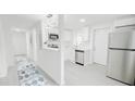 A modern kitchen with stainless steel appliances connects to a hallway at 800 Pritchard Avenue Ext # H3, Chapel Hill, NC 27516
