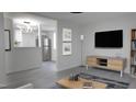 Open concept living room with a modern TV and sleek furniture at 800 Pritchard Avenue Ext # H3, Chapel Hill, NC 27516